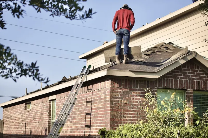 Professional roofer working on a residential roof in Richmond